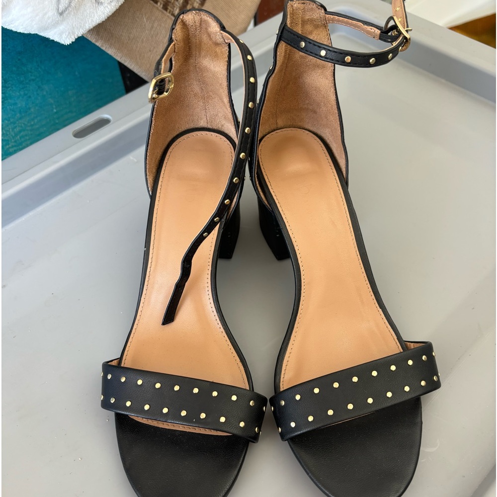 Black heels with gold embellishments that wrap around your ankle